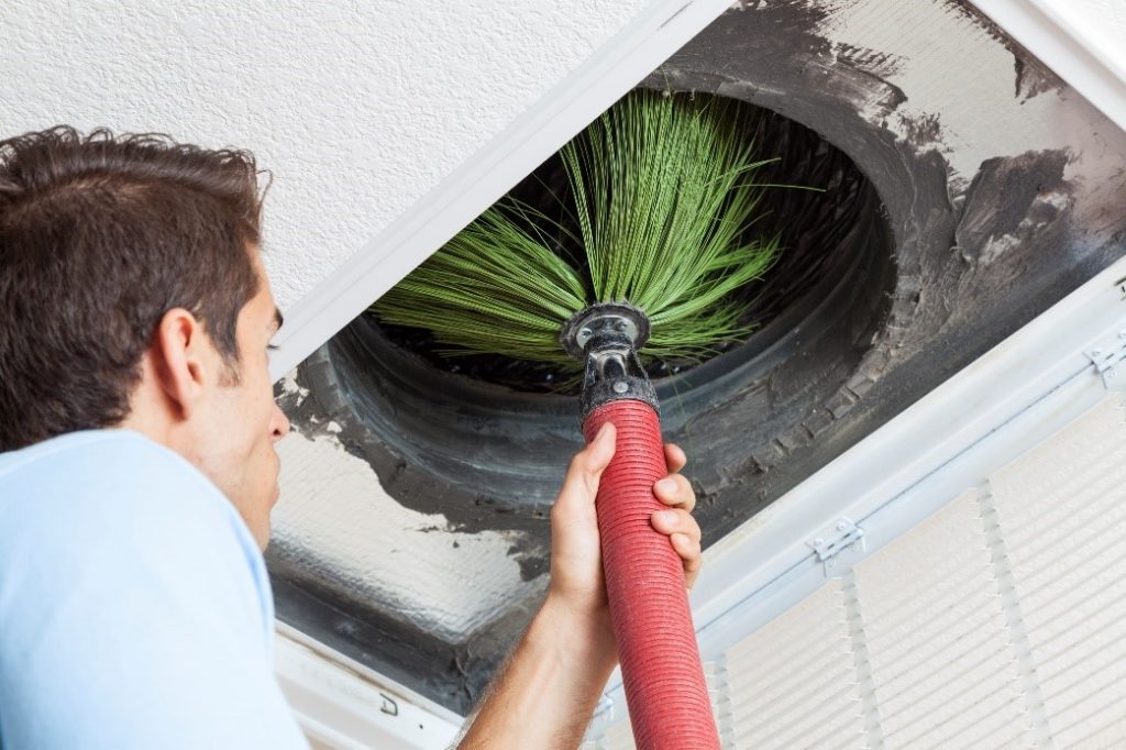 An HVAC Technician Holding Specialized Equipment To Clean an Air Duct | Duct Cleaning | Envirovac